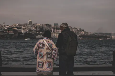 An older couple looking across the water at Galata